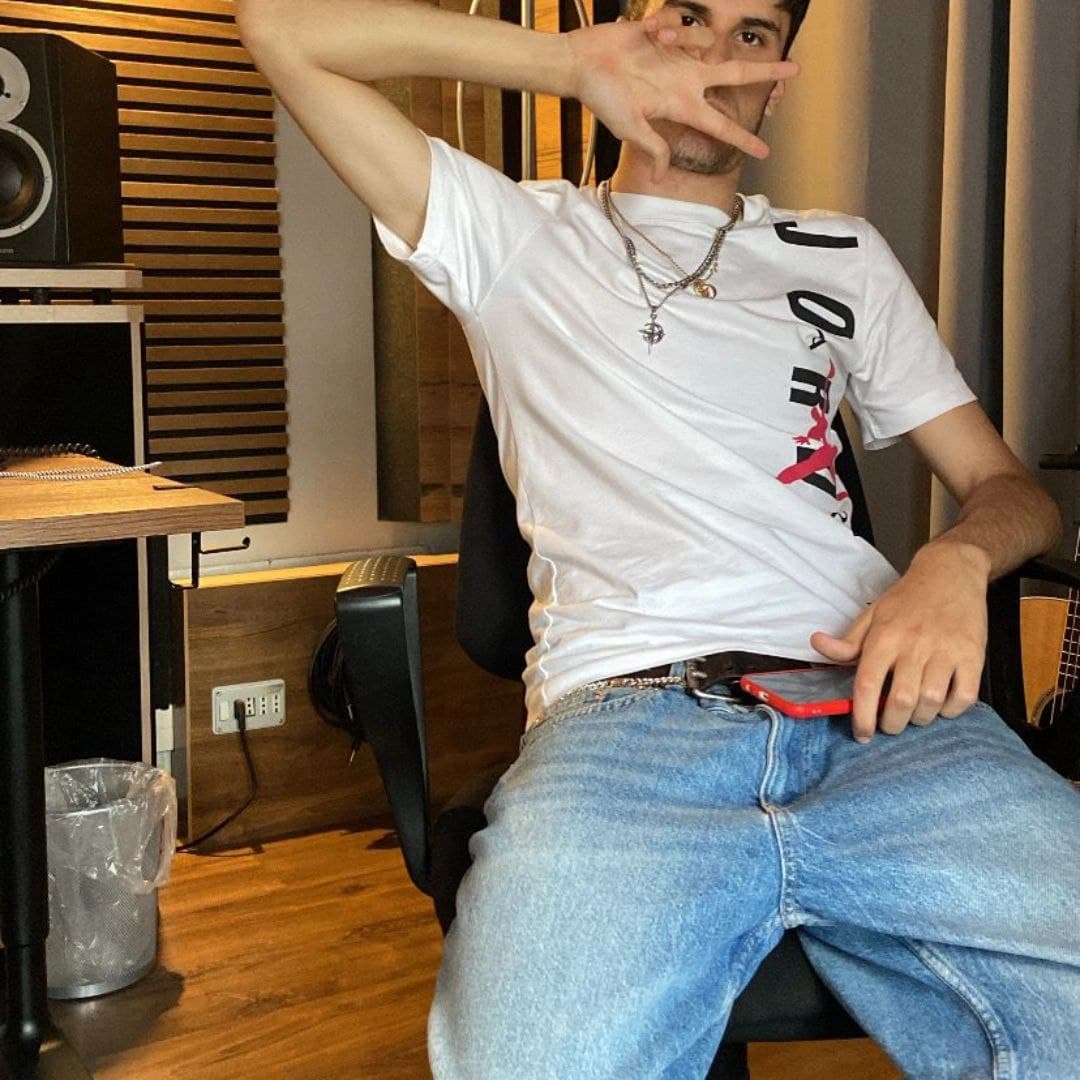 a man sitting in a chair in a recording studio